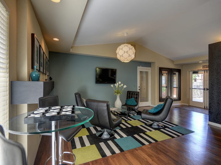 Office Interior with Glass Table, Black Sofa Chairs and Television